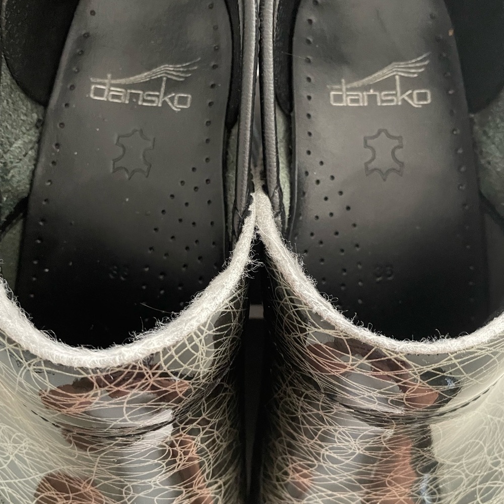 Dansko clogs. Black with white scribble.